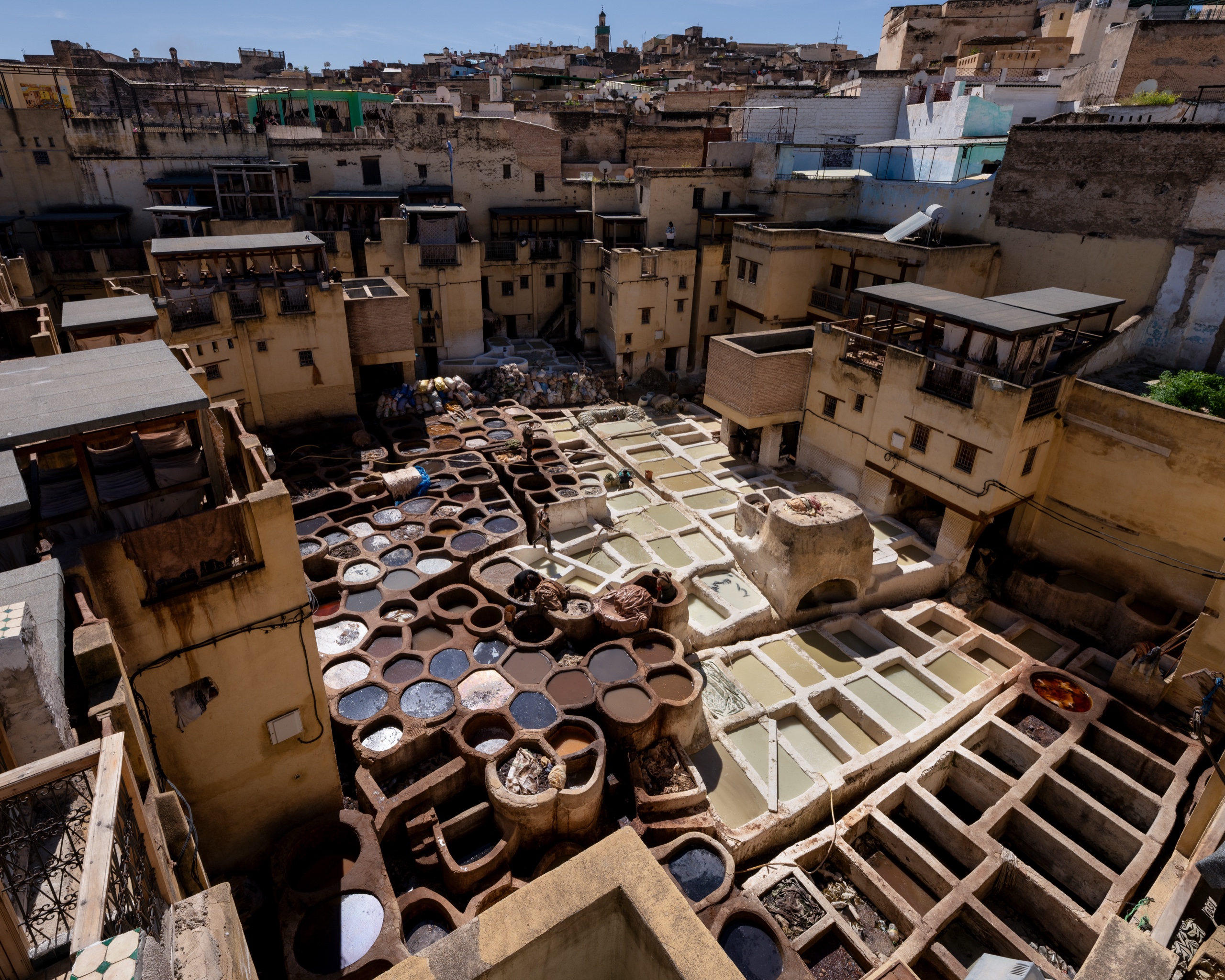 A traditional tannery in Morocco with circular dye vats viewed from above.